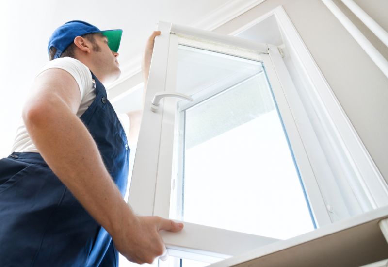 Professional inspecting a window frame